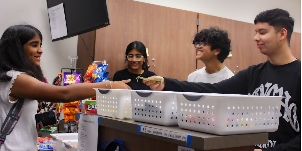 A customer purchases Extra Gum in the 15 & Mane School Store. Gum has been one of the most popular products in the school store.
